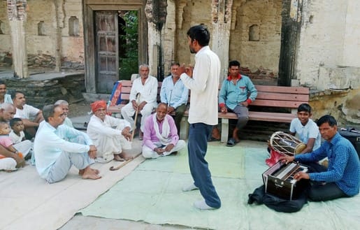 Information about schemes being given to villagers through folk songs