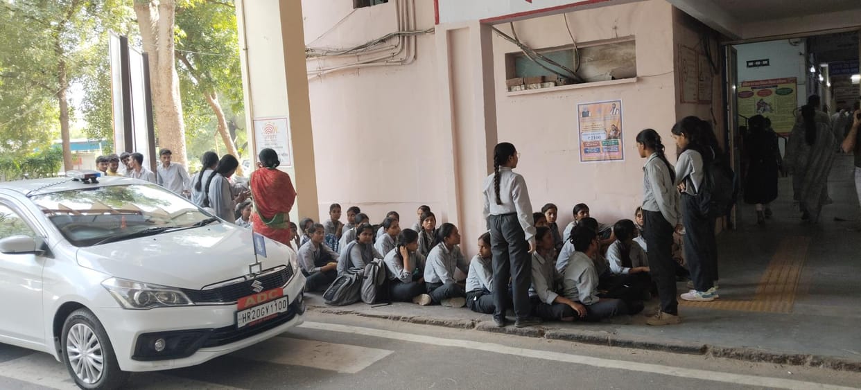 Students staged a protest in front of the ADC's car, demanding the end of the school's double shift system