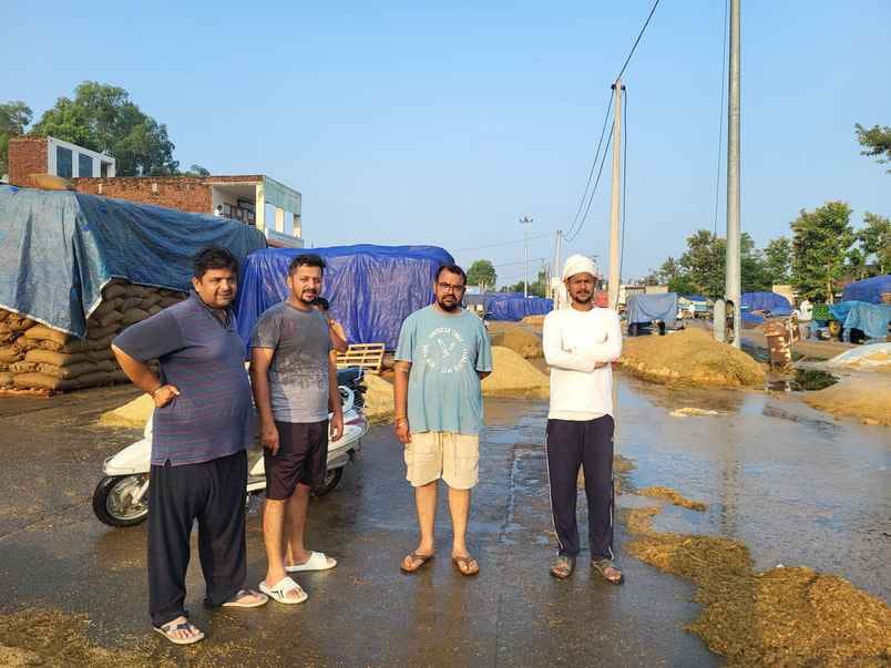 Paddy lying in the market was washed away in rain water