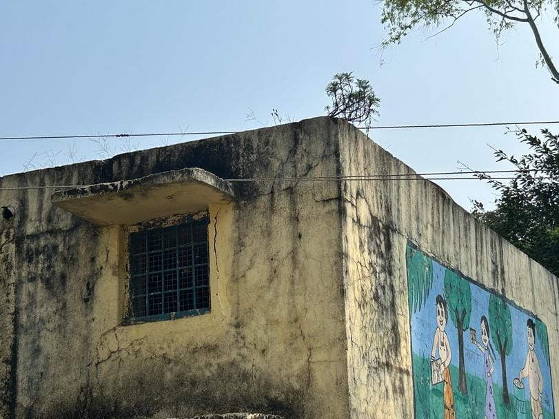 Electricity wires touch the school roof, children are studying under the shadow of danger.