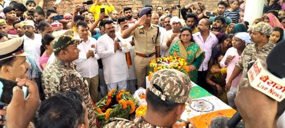 The village was filled with grief as the soldier's body arrived.