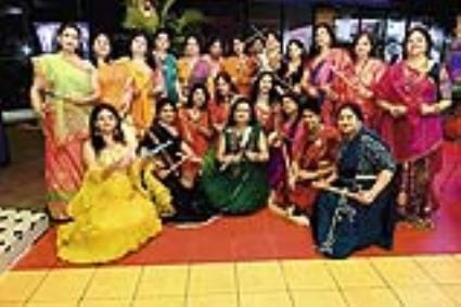 Women in traditional attire played Dandiya