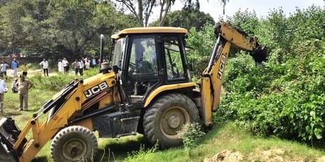 JCB used for construction of drain near the cemetery, illegal encroachments also removed
