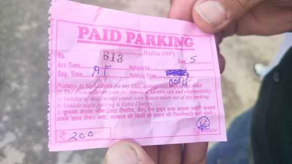 A slip of Rs 200 is being issued for vehicle parking.