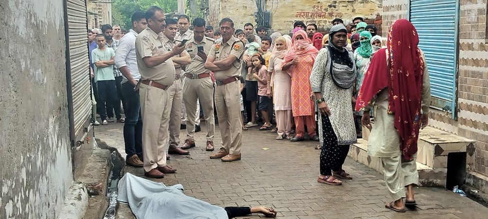 The young man was chased and hacked to death with an axe; angry family members refused to allow the body to be removed for six hours.