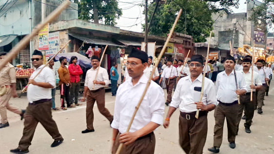 Volunteers carrying sticks participated in the city's march