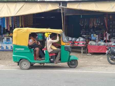 E-rickshaw converted into bullock cart, passengers crammed in
