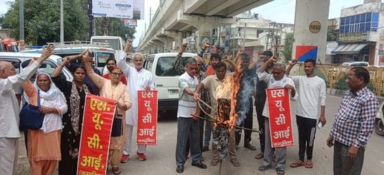 SUCAI workers burnt an effigy of US President Trump.