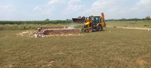 Bulldozers run on a 4-acre illegally developed colony