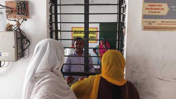 Pharmacist examines malaria suspect in old hospital
