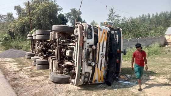 The driver was trapped in the cabin when the dumper overturned while unloading gravel.