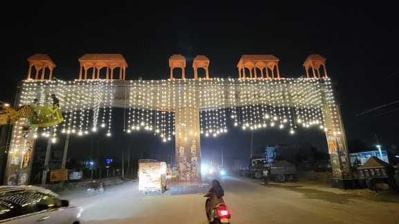 Welcome gates are illuminated with lights in the city, but not in the colonies.