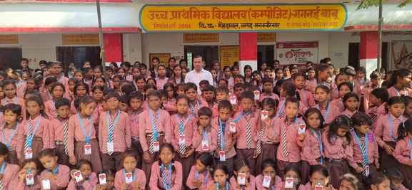 Children received identity cards at Gaganai Babu Composite School, their faces lit up.