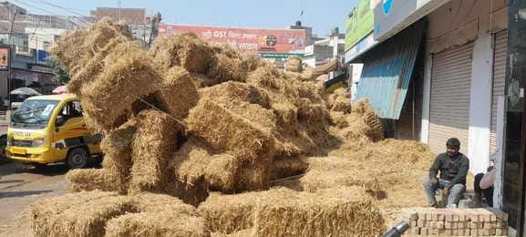 A trolley loaded with straw overturned, leaving commuters stranded for four hours.