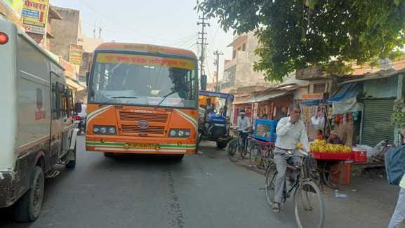 Bus and machine parked on the road, vehicles stuck in traffic jam