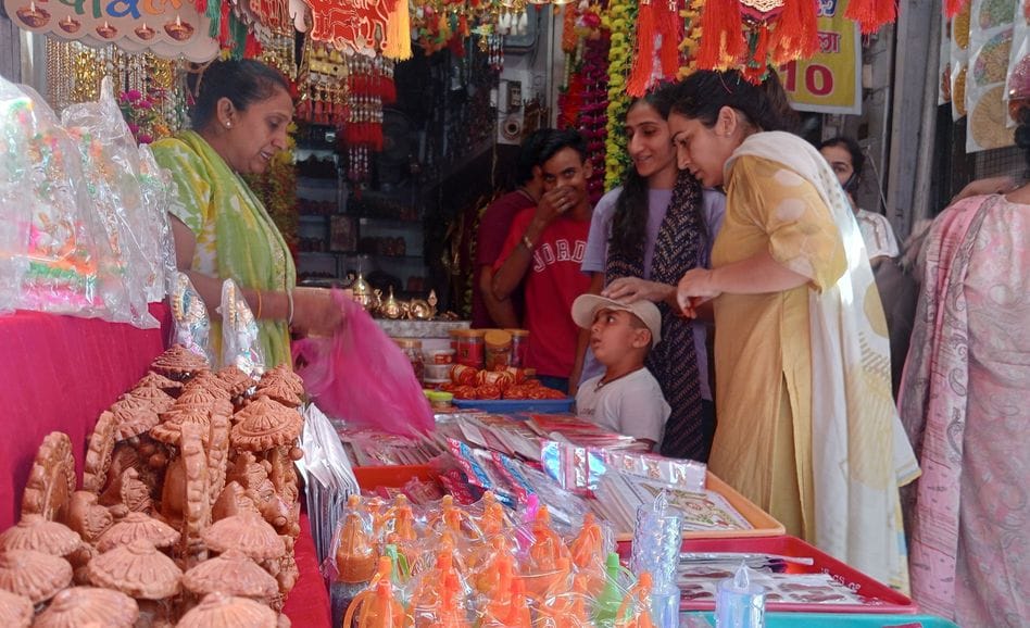 Stalls adorned with indigenous garlands and clay idols of Lakshmi and Ganesha
