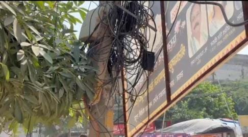Internet cables run alongside power lines on poles.