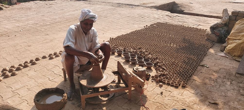 Earthen lamps still keep the flame of tradition alive in villages.