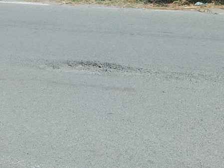 People are troubled by the deep potholes on the road