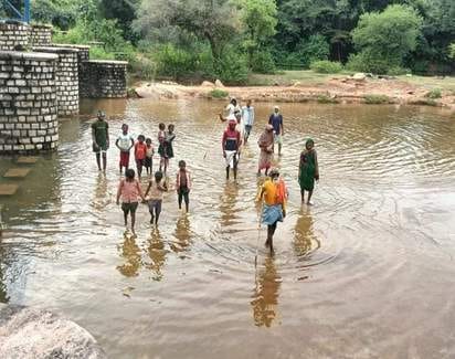The people of Hinaut Ghat bow their heads from the footpaths.