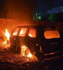 A car parked on a plot caught fire, another one survived.