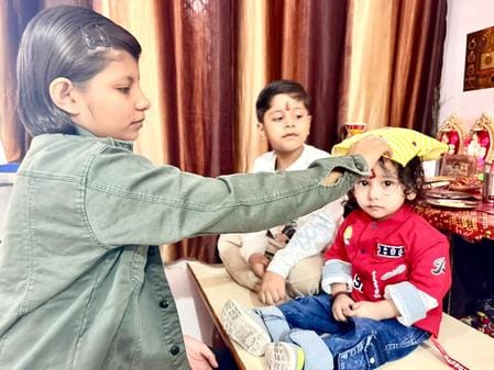 Sisters applied tilak to their brother and wished him a long life.Sisters applied tilak to their brother and wished him a long life.