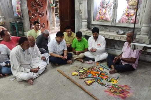 Wishing for happiness and prosperity by worshipping Govardhan, distributing Annakut Prasad