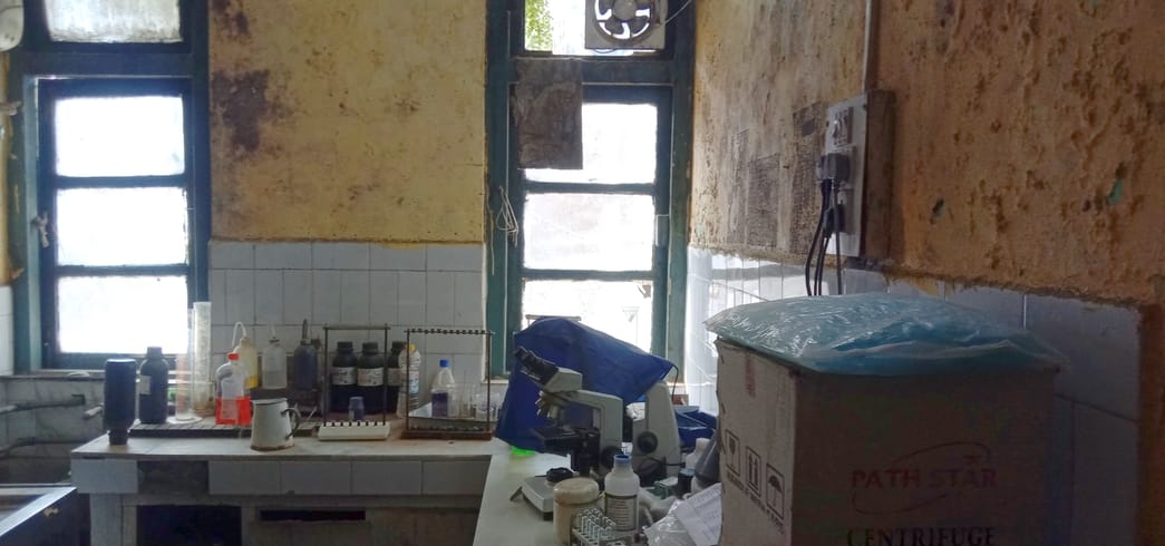 Doctors checking patients' pulse in an old, dilapidated building