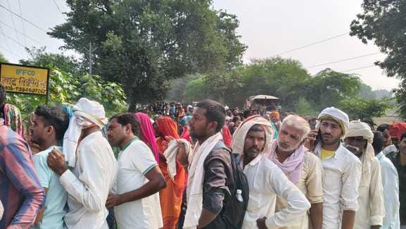 Farmers are seen standing in long lines as soon as the fertilizer center opens after Diwali festival.