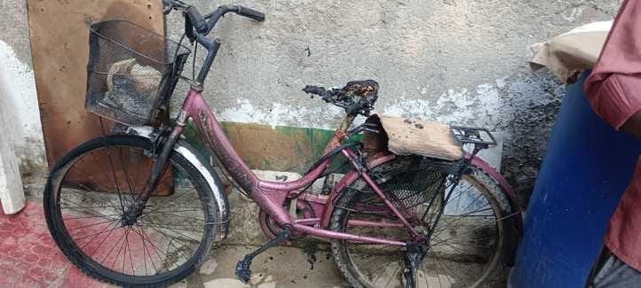 Two young men wearing helmets set fire to an e-rickshaw, bike and bicycle parked outside their house.