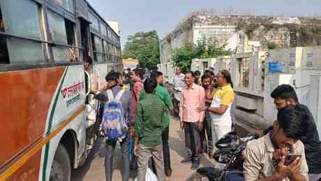 People returning to work after the festival, crowds gathered at the bus stand.