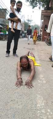 62-year-old Rajesh Kumar has been lying down at the Chhath Ghat for nine years.