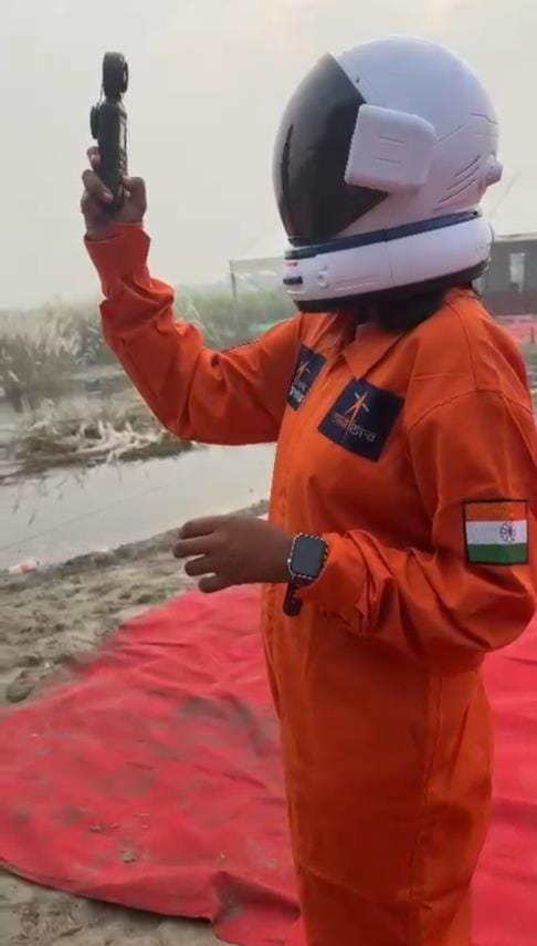 Girls view the moon through a telescope and satisfy their hunger with space food.