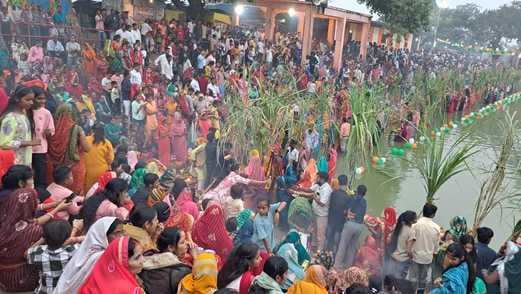 A flood of faith on the ghats, offerings to the setting sun