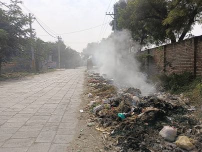 Northern winds bring some relief from air pollution, but garbage continues to burn