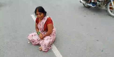 Women sit on the road to protest against non-payment of electricity bills
