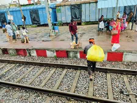 Foot overbridge showpiece, passengers crossing railway tracks risking their lives