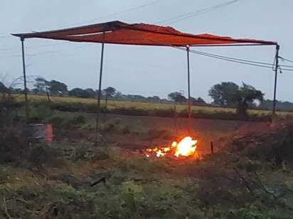 Due to rain, the funeral of an elderly woman had to be conducted under a tent.
