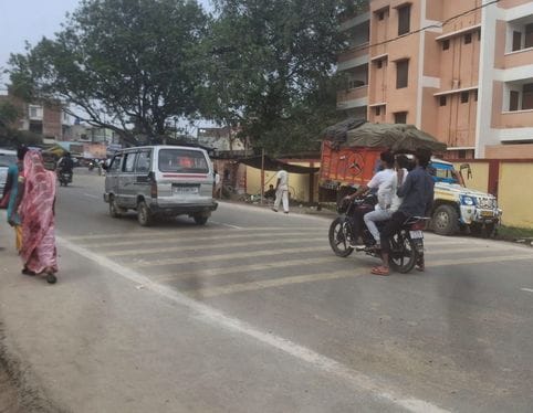 Violation of rules: Bike riders are speeding without helmets and carrying three passengers.
