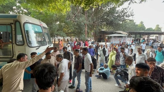 Passengers staged a sit-in at the bus stand after buses were not available for an hour and a half.