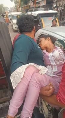 Sister's life stuck in traffic jam...brother runs away carrying her in his lap.