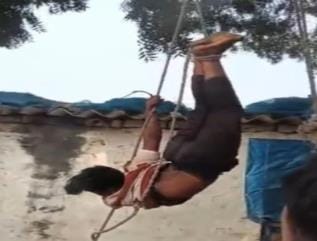 A teenager was tied with a rope and hung upside down from a tree for stealing a mobile phone.
