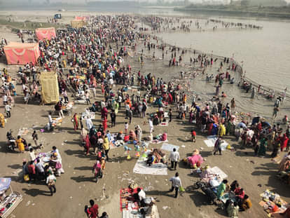 Devotees take a dip in the Yamuna on Kartik Purnima