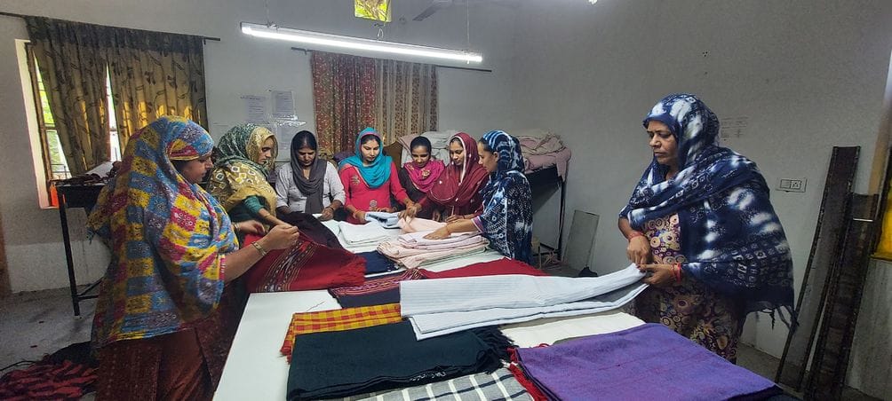 Women from dozens of villages are weaving threads of hope on handlooms.