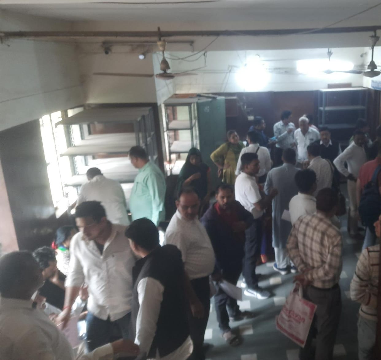 There was a crowd of people getting the deed done at the sub-registrar office.