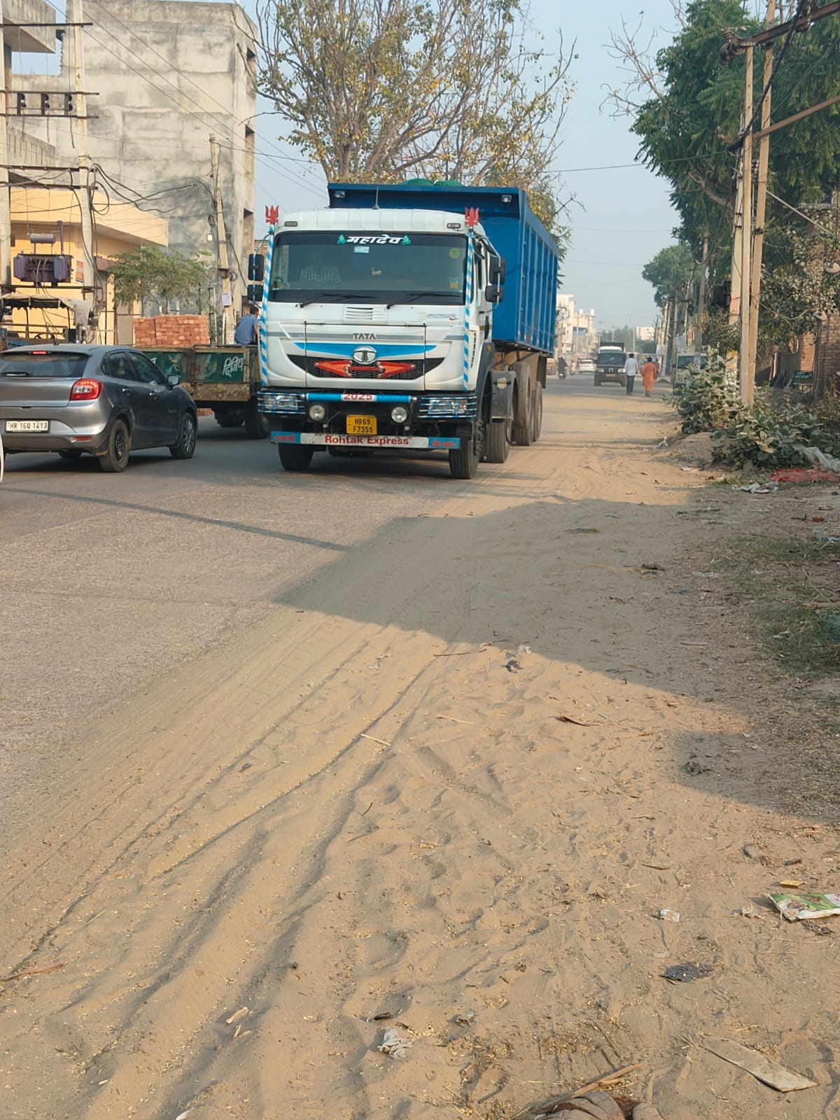 Officials forgot to remove sand from the footpath of Tosham bypass, now dust is flying.