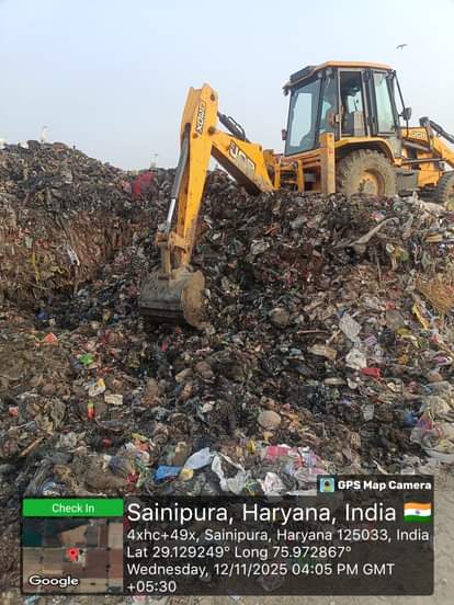 JCB runs in the dumping station, work begins to remove 15 feet high mountain of garbage