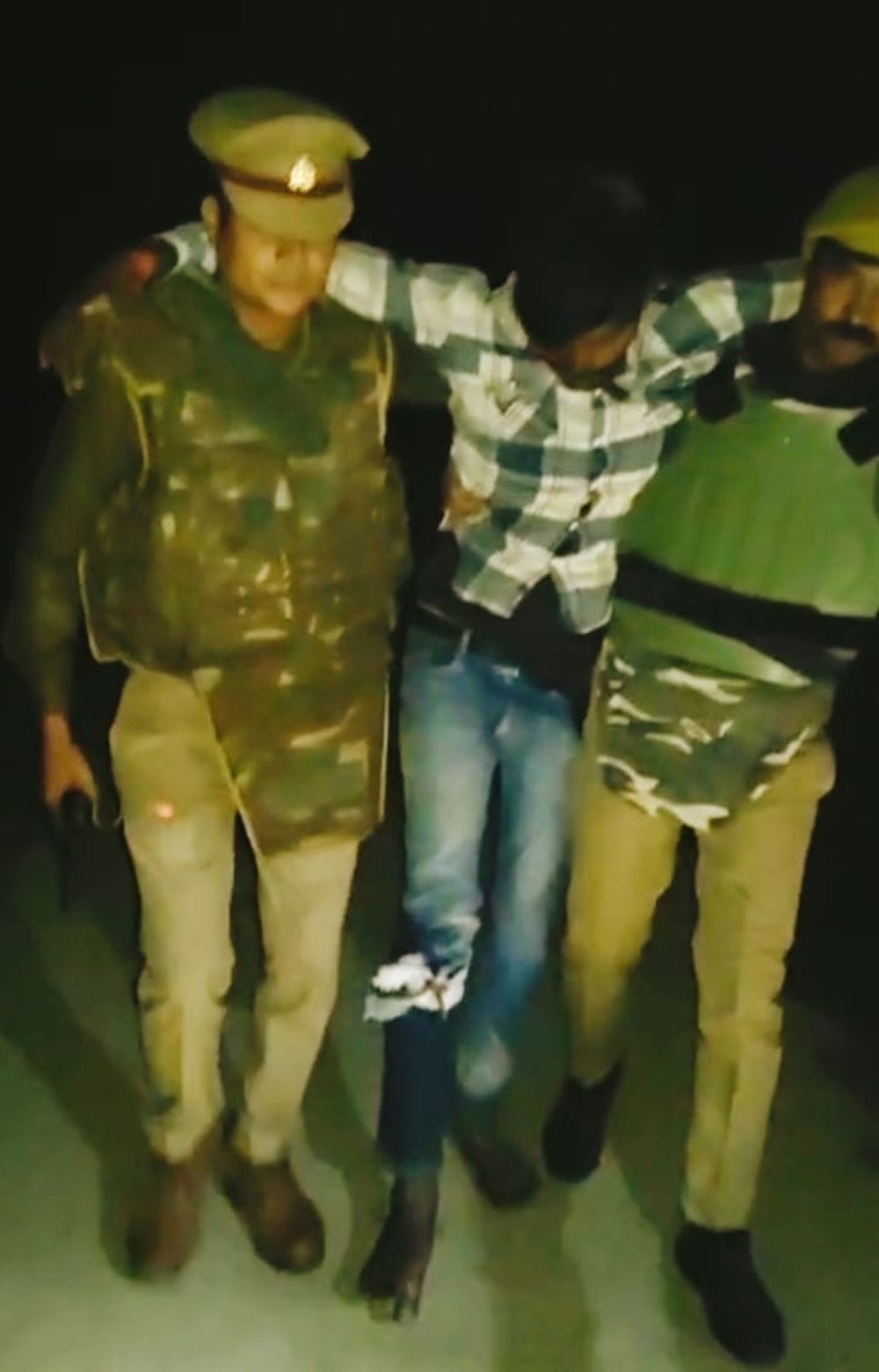 Police taking away Shamsher, who was injured by police bullets in the encounter.