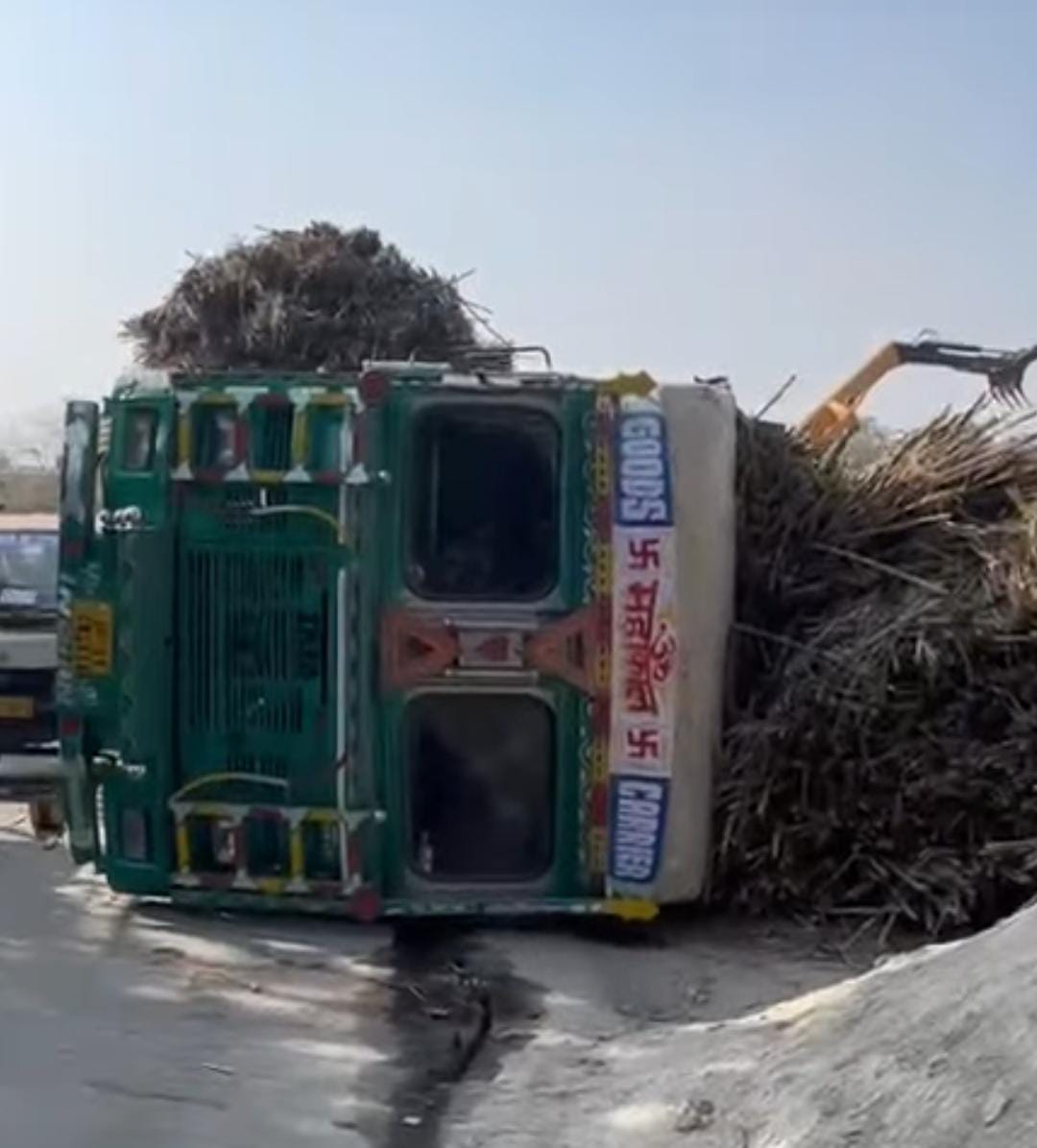 The road was blocked on Daurala Road after an overloaded truck carrying sugarcane overturned.