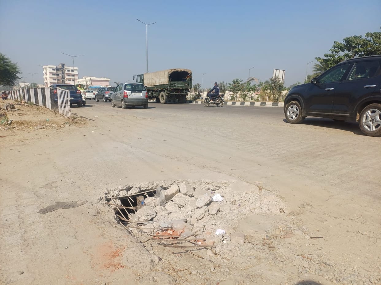Overloaded vehicles in front of Night Food Street cause the drain to collapse.
